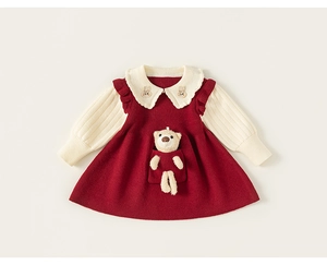 Detail of red knit A-line dress featuring white Peter Pan collar and 3D plush bear toy