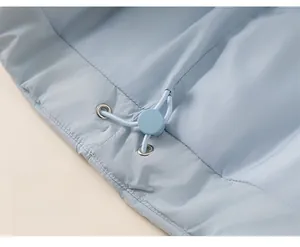 Detail of light blue waterproof fabric with adjustable drawstring and metal eyelets