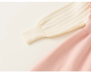 Detail of ribbed knit texture with ivory lantern sleeves and ruffled collar for girls