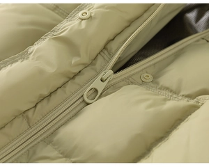 Detail of olive green puffer jacket with quilted padding, zip closure and snap buttons