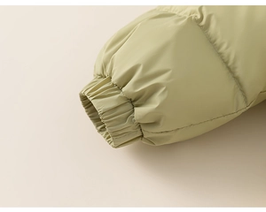 Close-up of elastic cuffs and water-resistant sage green fabric on kids' down jacket