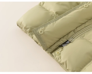 Detail of child down jacket zipper with silver heat-reflective lining for thermal warmth