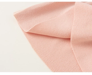 Close-up of pink knit dress showing high-quality vertical rib texture and neat stitching