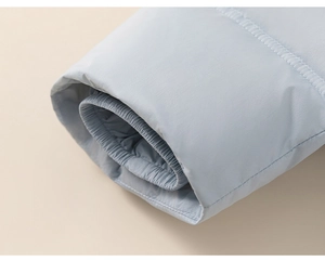 Close-up of windproof elastic cuffs on light blue children's winter down jacket