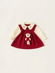 Red and cream knitted girl's dress featuring a Peter Pan collar and 3D bear doll