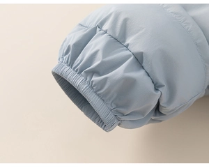 Detailed macro view of the elastic cuffs and high-quality stitching on the blue down jacket