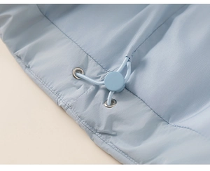 Detailed macro view of the light blue puffer jacket hem with elastic drawstring and stopper