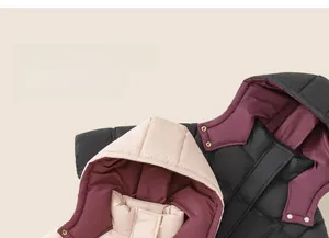 Close-up of color-block hooded winter jacket with metal snap buttons and quilted texture