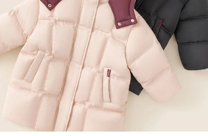 Detail view of pink quilted down coat featuring contrasting burgundy hood and flap pocket