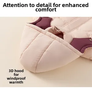 Detail view of children's down jacket hood with beige exterior and purple lining