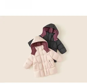 Flat lay of kids' puffer jackets in black and beige with diamond quilting and hooded collar