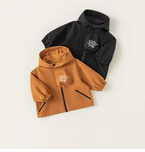 Detail of kids outdoor hooded jackets in black and yellow with hiking slogan prints