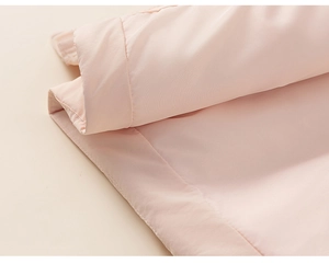 Close-up of pink down jacket cuff with high-quality stitching and smooth fabric