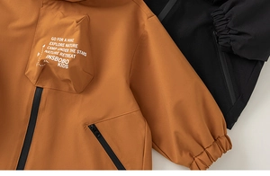 Detail of outdoor kids jacket with windproof fabric and Go For A Hike slogan print