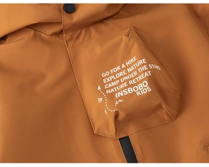 Macro detail of kids outdoor jacket fabric texture with explore nature printed pocket