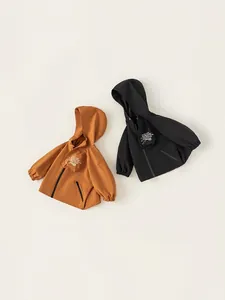 Child hooded windbreaker jacket with cargo pocket in caramel and black outdoor colors