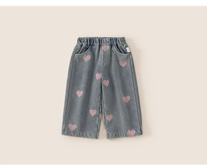Detail of girls denim jeans with pink heart embroidery and comfortable elastic waistband