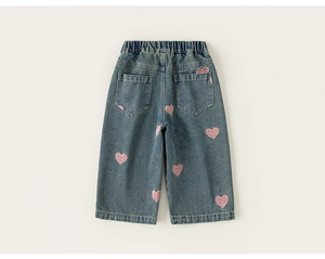 Detail of girls heart pattern denim jeans with pink sequins and elastic waistband