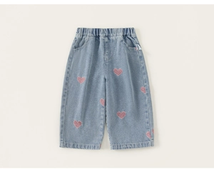 Detailed macro view of light blue denim pants with pink heart embroidery and elastic waist