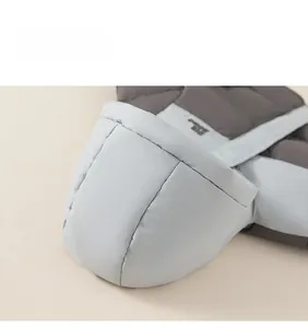 Detail view of quilted puffer jacket cuff with blue and grey color block design