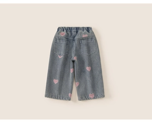 Detail of girls denim wide-leg jeans featuring pink sequin hearts and elastic waist