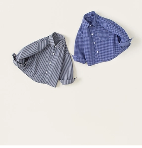 Flat lay of boys cotton long-sleeve shirts featuring blue stripes and grid patterns