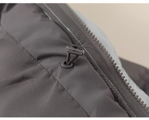 Detailed macro view of an adjustable drawstring and side zipper on a warm winter jacket