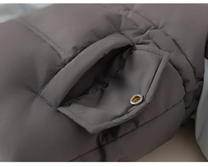 Close-up of pocket detail on girl's winter down jacket with premium silver button