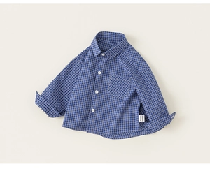 Close-up of blue and white checkered pattern fabric on long-sleeved kids shirt