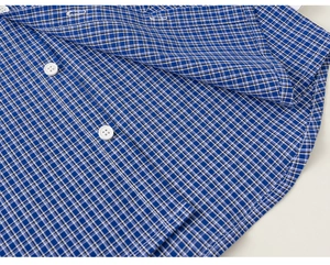 Detail of blue and white gingham shirt showing resin buttons and fine cotton texture