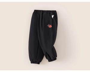 Close-up of children's black jogger pants featuring colorful Fu character embroidery