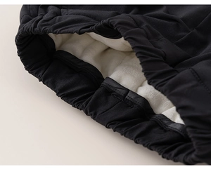 Close-up of children's thick fleece-lined winter trousers with warm sherpa lining