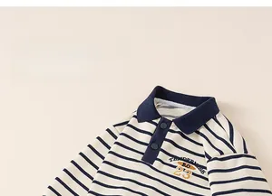 Detail of children's striped polo sweatshirt featuring navy collar and tenderness embroidery