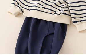 Detail of boys striped sweatshirt and navy joggers showing soft texture and stitching