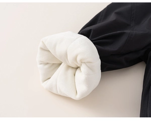 Close-up of kids warm winter trousers with thick white fleece lining and black windproof fabric
