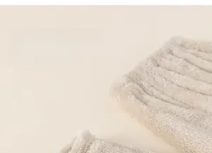 Close-up of thick beige plush fabric showing soft texture of children's thermal pajamas