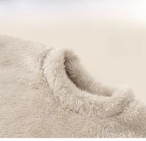 Detail of soft beige plush fleece fabric and classic round neckline on kids pajama top