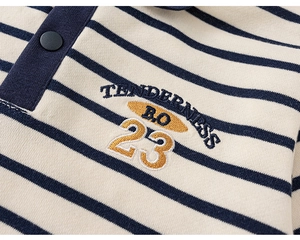Close-up of boys striped polo sweatshirt featuring detailed embroidery and navy texture