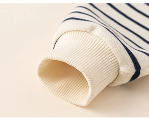 Macro shot of ribbed cuffs and striped cotton fabric on boys casual sweatshirt