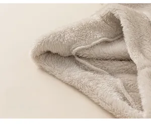 Detail shot of cozy cream fleece fabric and loose hem stitching on children pajamas