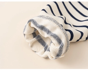 Detailed close-up of striped cotton sleeve with soft French terry lining texture