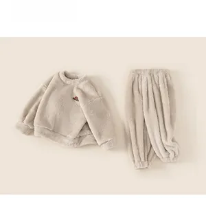 Detailed view of cream white thick fleece children pajamas set with soft textured fabric