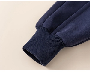 Detail of navy blue ribbed cuffs on boys striped sweatshirt for a windproof fit