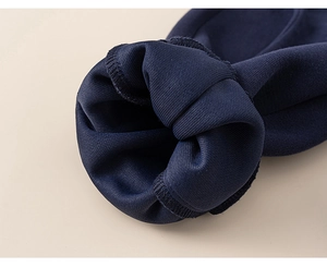 Close-up of dark blue ribbed knit cuffs on boys' sweatshirt set showing thick texture