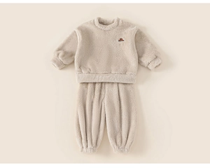 Detail of baby warm fleece sweatshirt and trousers set with soft sherpa texture