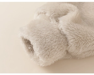 Detailed macro view of soft cream plush fabric texture on children winter pajamas