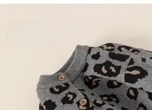 Detailed macro view of the leopard print knit cardigan with brown resin buttons