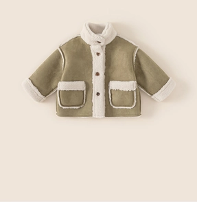 Detailed view of kids winter jacket with green suede fabric and white faux fur trim