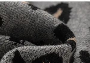 Close-up of soft leopard print knit fabric showing detailed texture and high-quality yarn