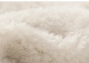 Close-up macro view of soft off-white lamb wool lining for a children's warm winter jacket